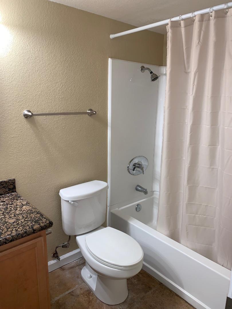 105 Reflections Drive, Unit 15 San Ramon, CA 94583 - Photo 27 of 42 a white toilet sitting next to a bath tub