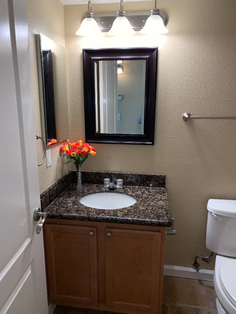 105 Reflections Drive, Unit 15 San Ramon, CA 94583 - Photo 6 of 42 a bathroom with a sink vanity mirror and toilet