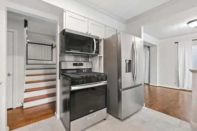 a kitchen with a refrigerator stove and microwave