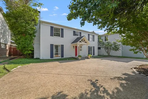 a front view of a house with a yard and a garage