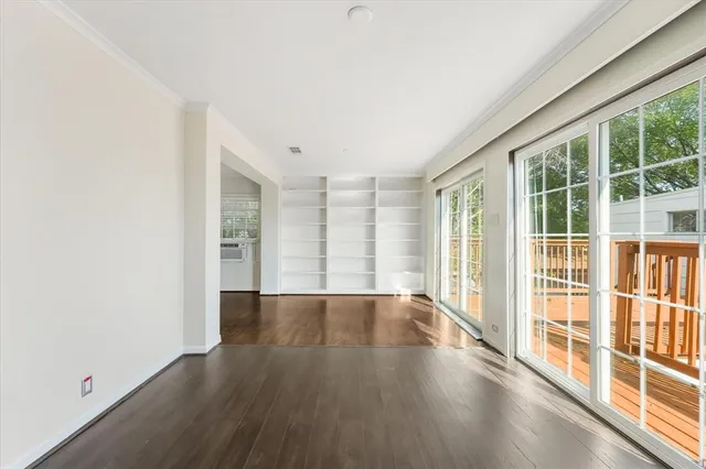 wooden floor in an empty room with a window