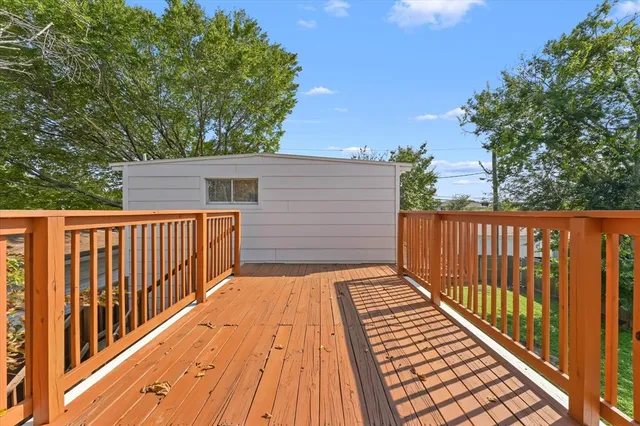 a view of backyard with wooden floor and fence