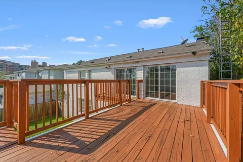 a view of balcony with wooden floor and fence