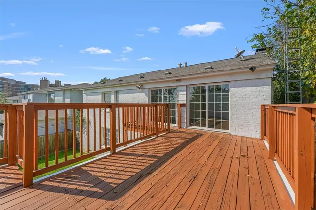 a view of balcony with wooden floor and fence