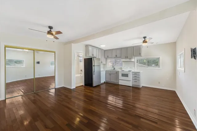 a view of a kitchen with wooden floor and a refrigerator
