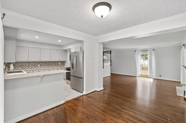 a view of a kitchen with a sink dishwasher stove and kitchen island