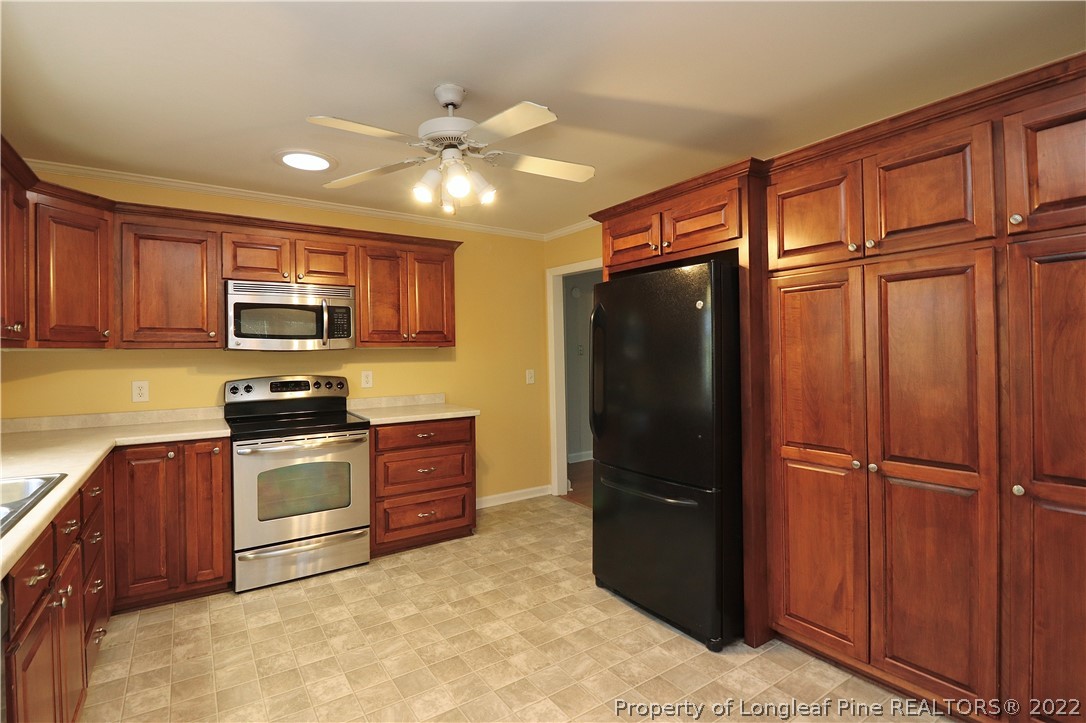 564 Shady Lane Road Carthage, NC 28327 - Photo 11 of 21 a kitchen with stainless steel appliances granite countertop a refrigerator stove and microwave