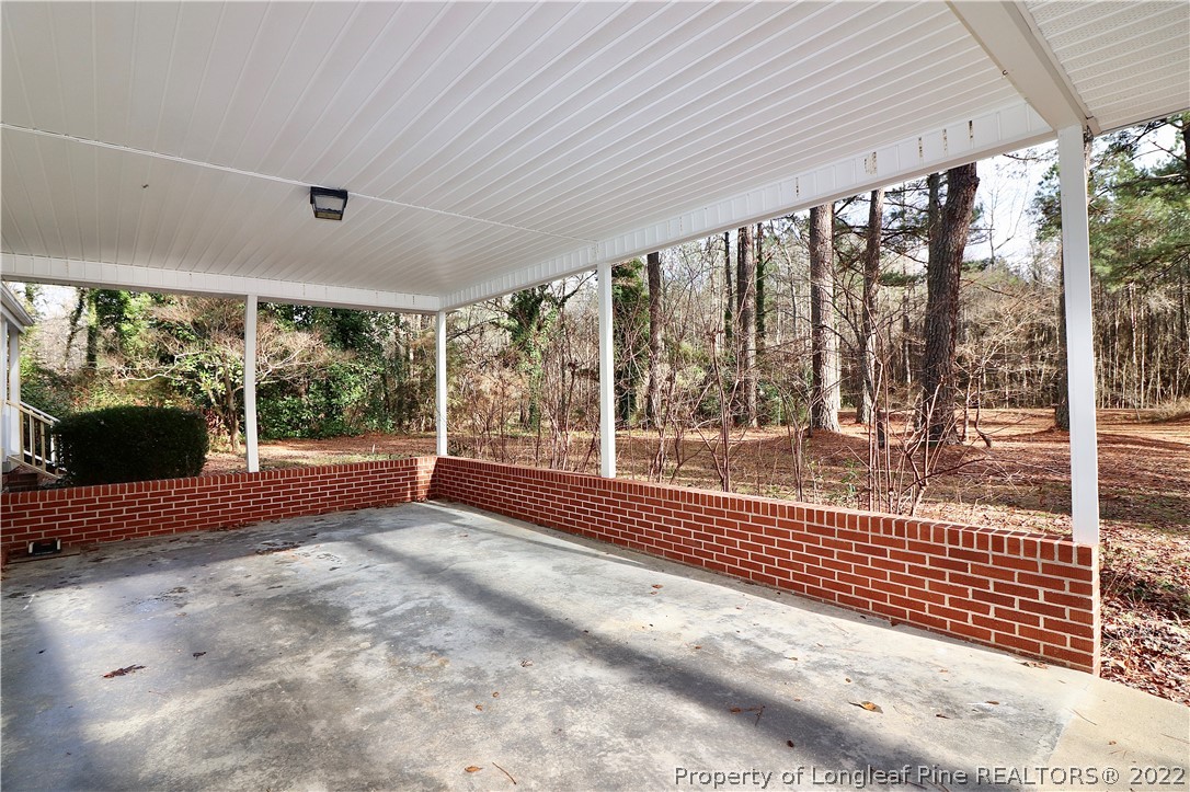 564 Shady Lane Road Carthage, NC 28327 - Photo 17 of 21 a view of an empty room with a fireplace and a large window