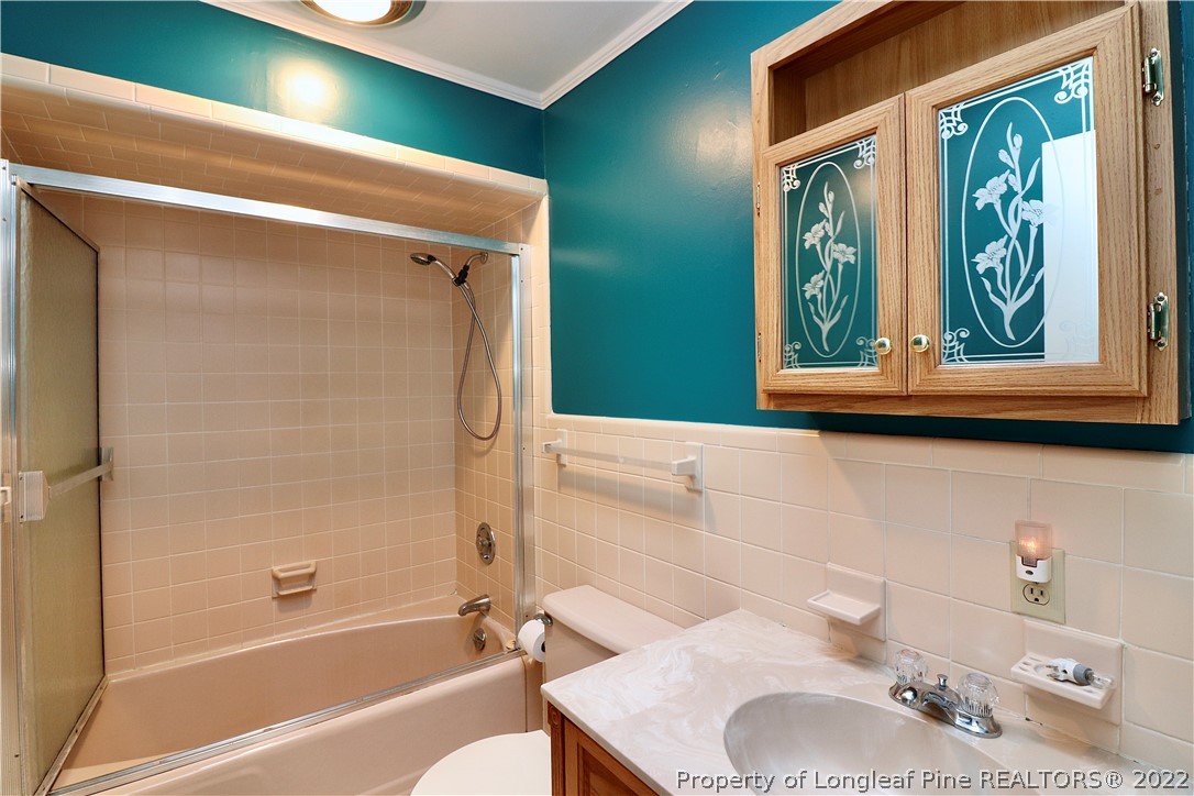 564 Shady Lane Road Carthage, NC 28327 - Photo 8 of 21 a bathroom with a granite countertop sink and a mirror
