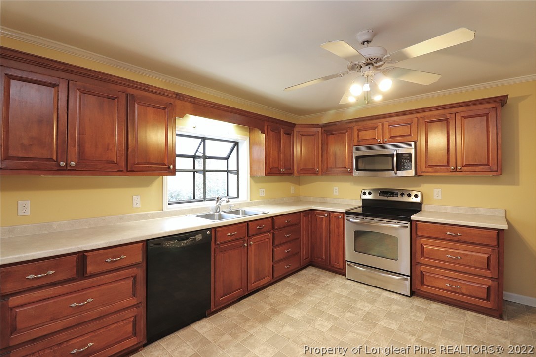 564 Shady Lane Road Carthage, NC 28327 - Photo 10 of 21 a kitchen with stainless steel appliances granite countertop wooden cabinets and a stove top oven