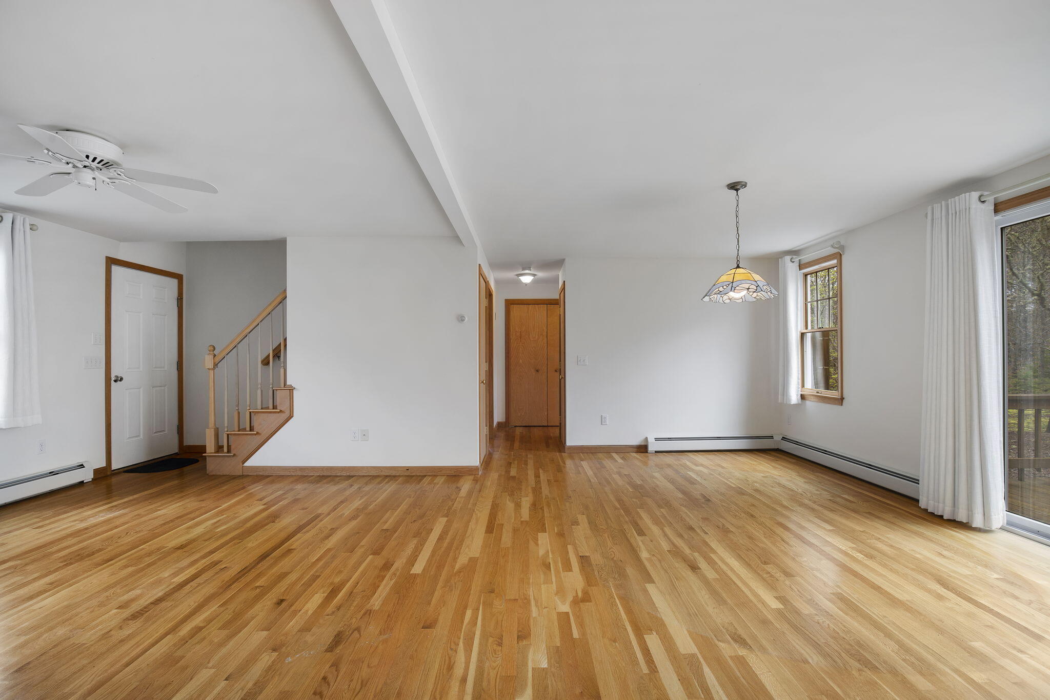 65 Whitney Road Eastham, MA 02642 - Photo 20 of 41 a view of an empty room with wooden floor and a window