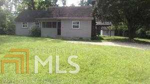 9045 Clark Road Fairburn, GA 30213 - Photo 1 of 1 a backyard of a house with yard and outdoor seating