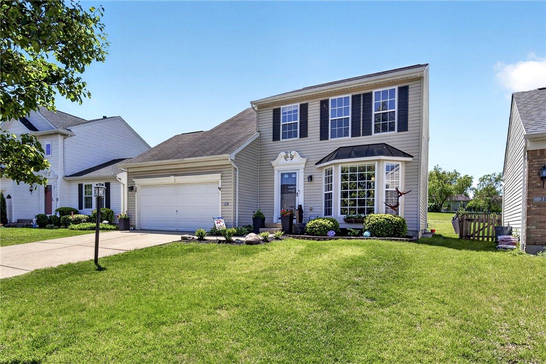 39 Holly Court Springboro, OH 45066 - Photo 3 of 42 This charming suburban home features a well-maintained lawn and a two-story design.