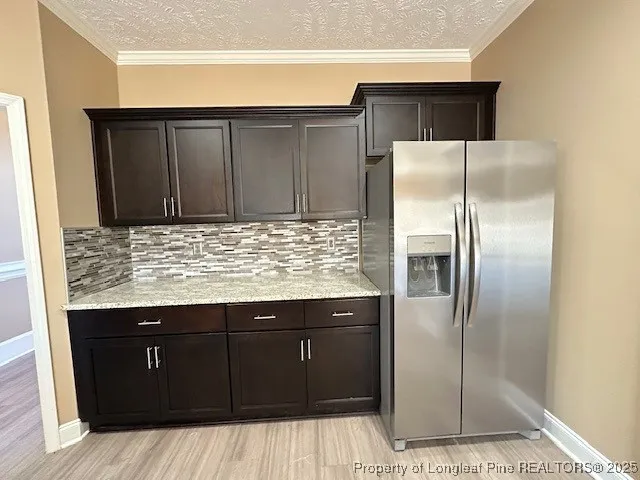 a kitchen with a refrigerator and cabinets