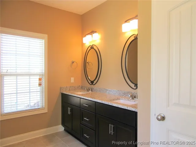 a bathroom with bathtub and window
