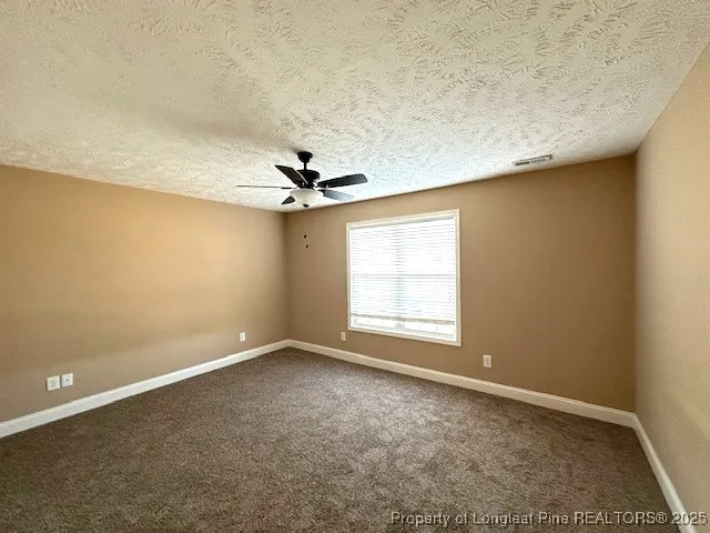 a view of empty room with a ceiling fan