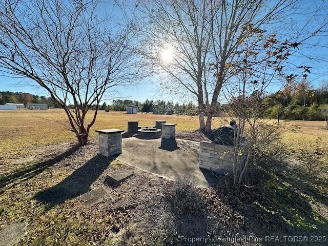 a view of a yard with wooden fence