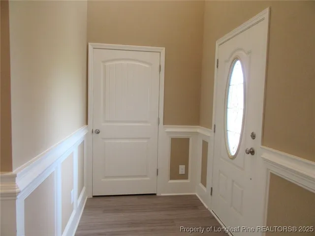 a view of a room with wooden floor and window