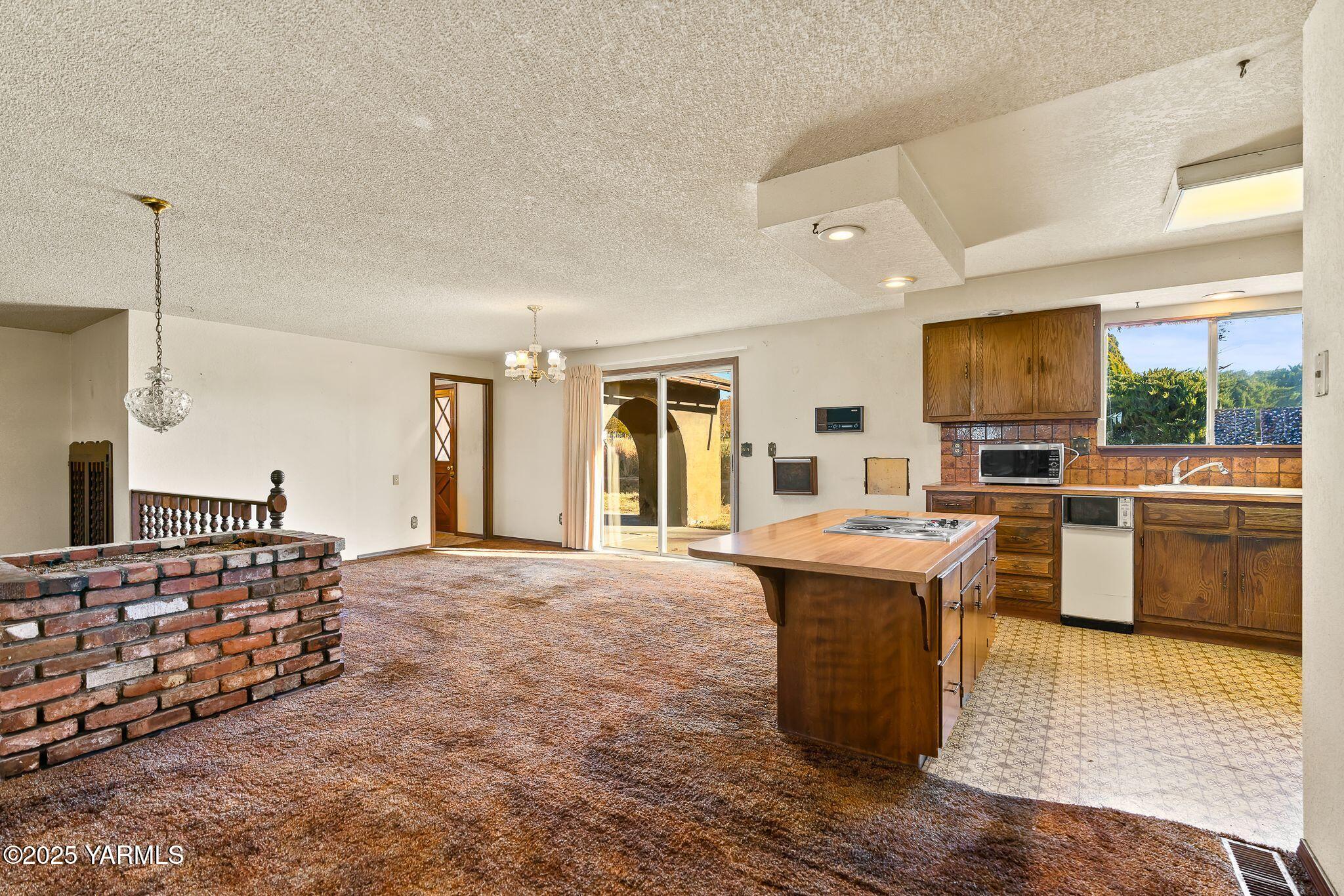 151 Morrow Road Moxee, WA 98936 - Photo 7 of 34 a living room with fireplace furniture and a flat screen tv