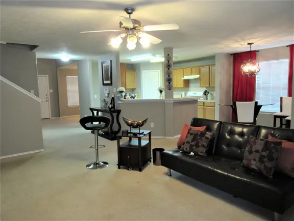 a living room with furniture and a chandelier
