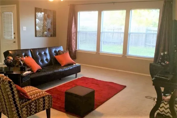 a living room with furniture and a window