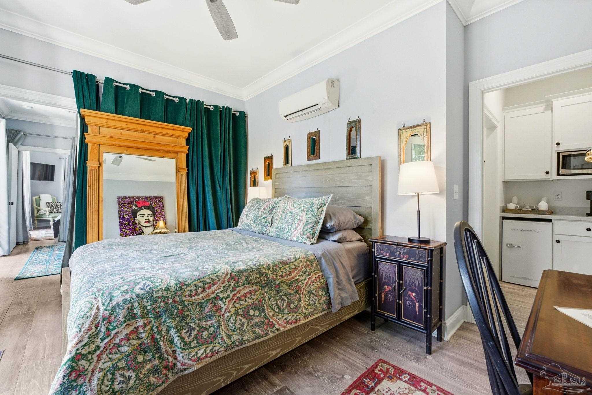 714 East La Rua Street Pensacola, FL 32501 - Photo 47 of 63 a bedroom with a bed next to a window with kitchen view