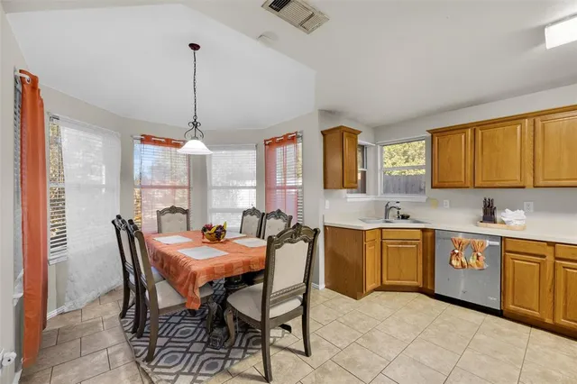 a dining room with furniture a chandelier and window