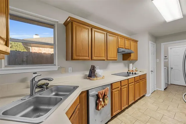 a kitchen with stainless steel appliances granite countertop a sink stove and cabinets
