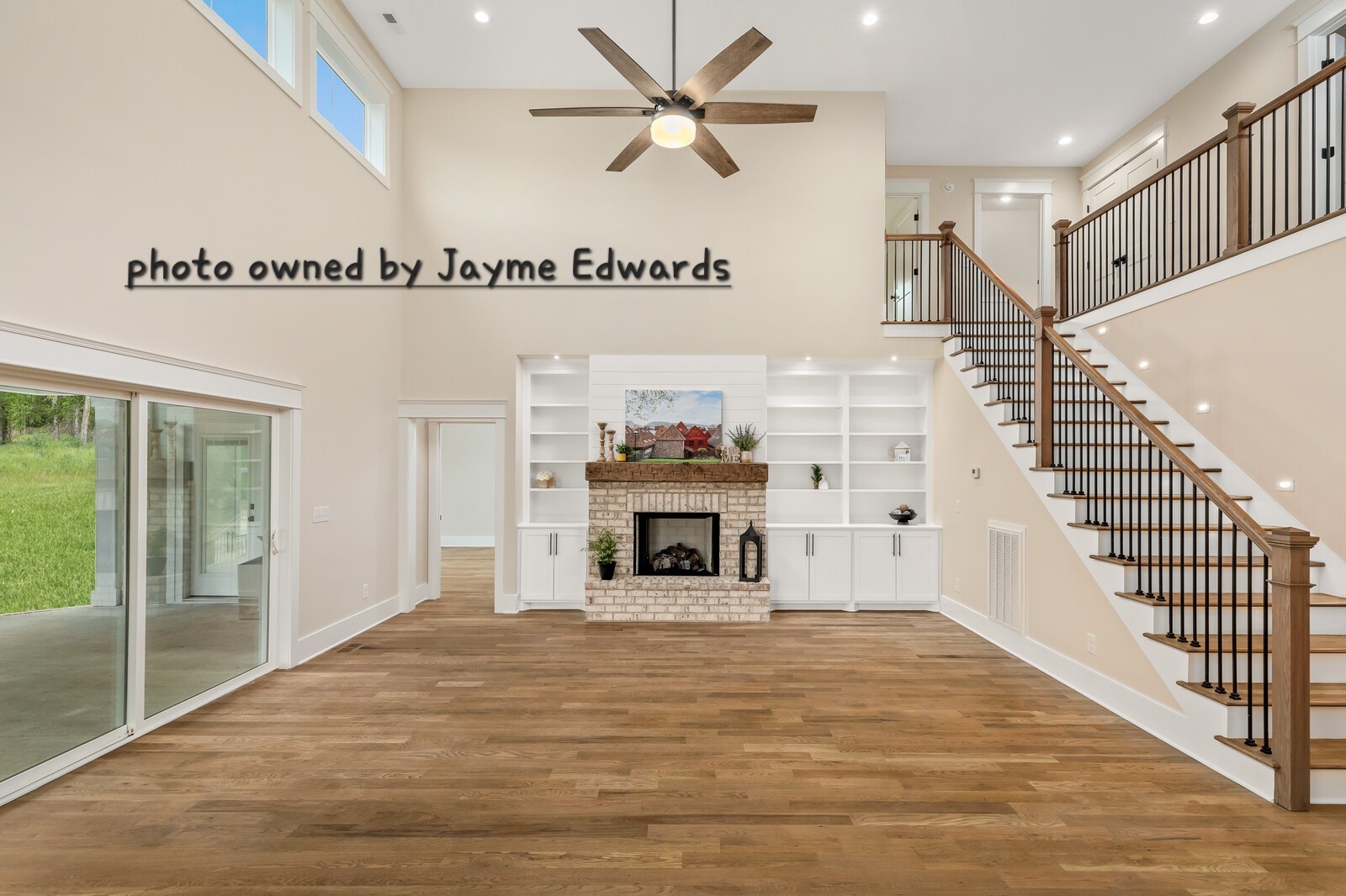 1235 Cliff Amos Road Spring Hill, TN 37174 - Photo 10 of 16 a view of a livingroom with a fireplace a ceiling fan and windows