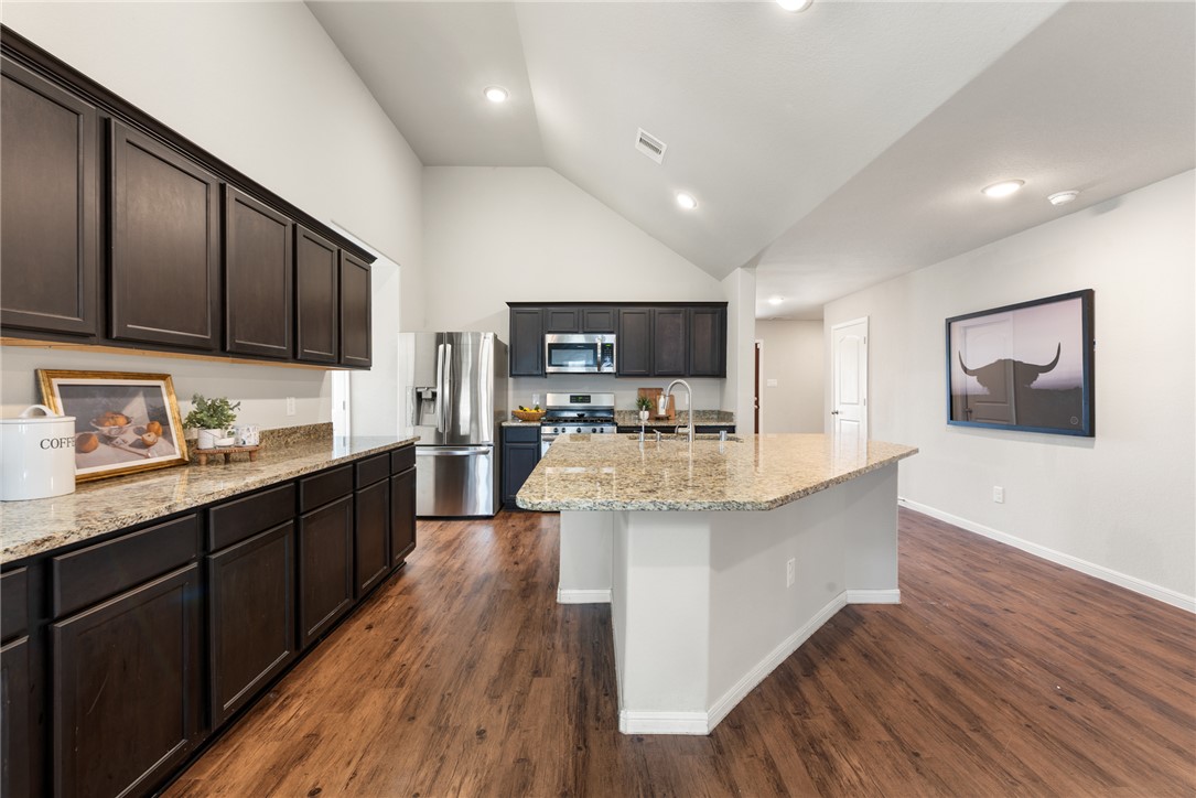 2018 Eagle View Drive Navasota, TX 77868 - Photo 6 of 28 a large kitchen with stainless steel appliances wooden floors and wooden cabinets
