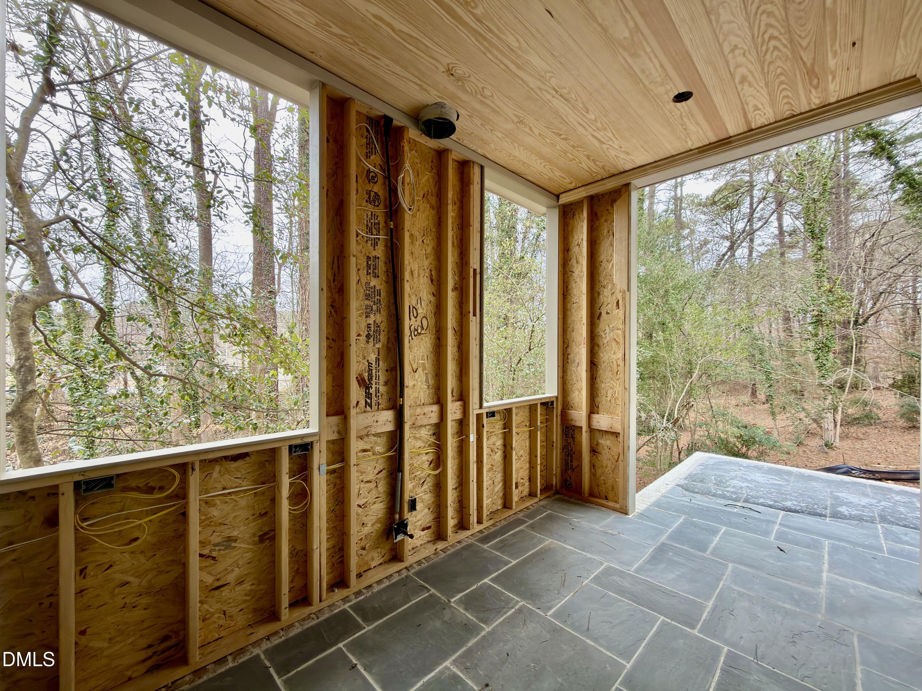 4801 Rampart Street Raleigh, NC 27609 - Photo 31 of 51 a view of a porch with wooden floor and outdoor space