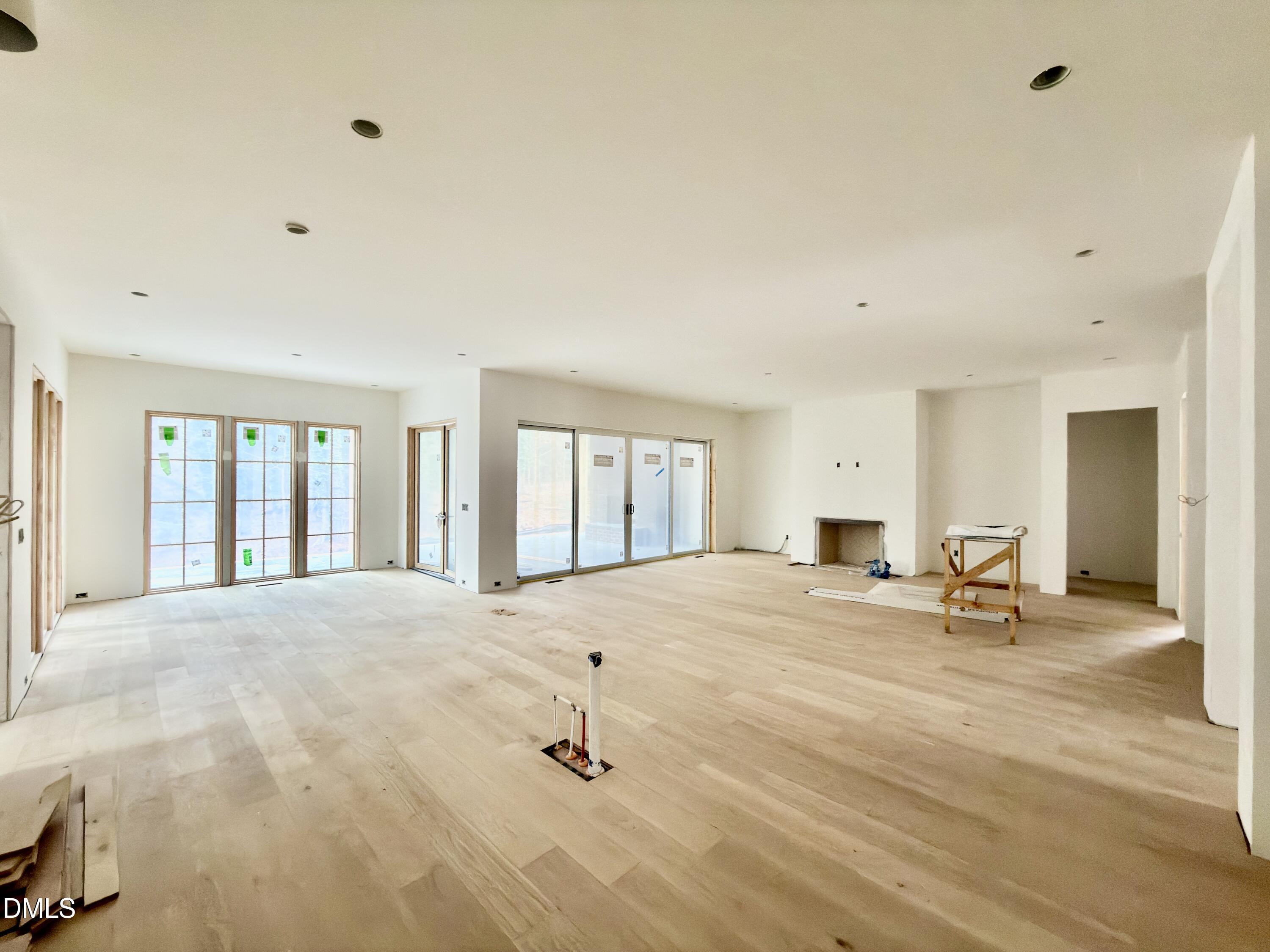 4801 Rampart Street Raleigh, NC 27609 - Photo 10 of 51 a view of a livingroom with wooden floor and a window