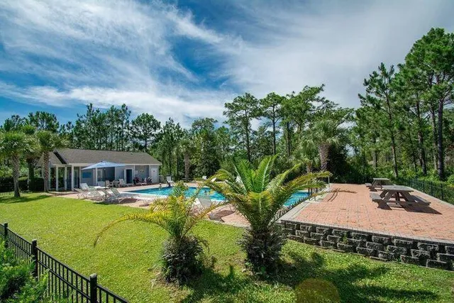 a view of swimming pool with outdoor seating and plants