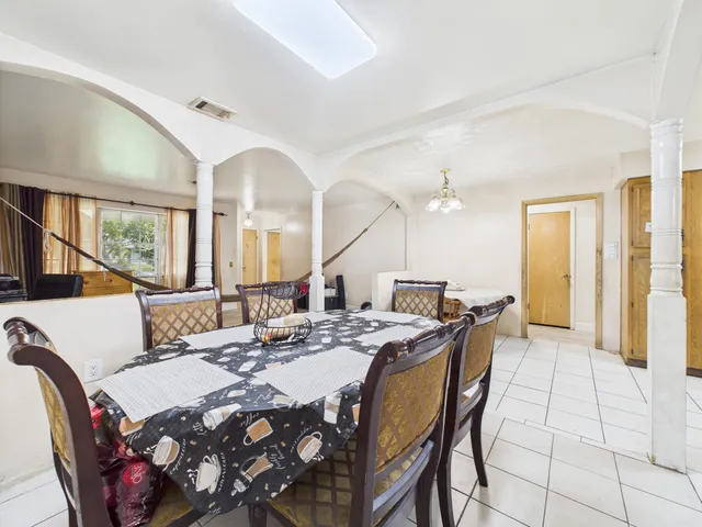 a view of a a dining room with furniture window and wooden floor