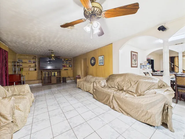 a living room with furniture and kitchen view