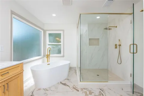 a bathroom with a bathtub and shower