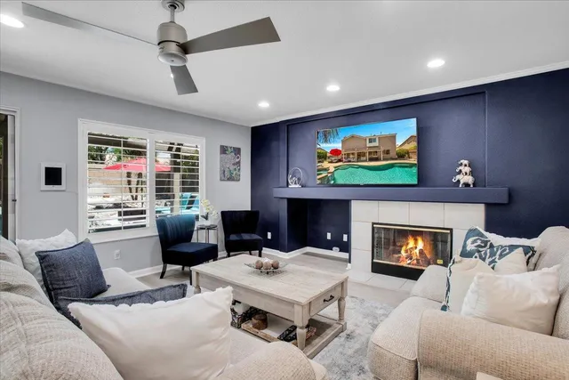 a living room with furniture a fireplace and a flat screen tv