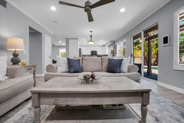 a kitchen with stainless steel appliances white cabinets a sink and a stove