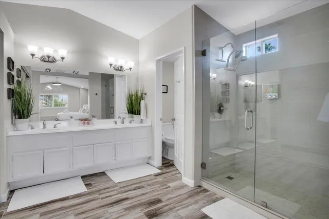 a bathroom with a toilet sink and shower