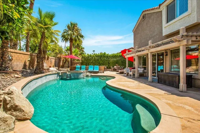 a view of a swimming pool with an outdoor seating
