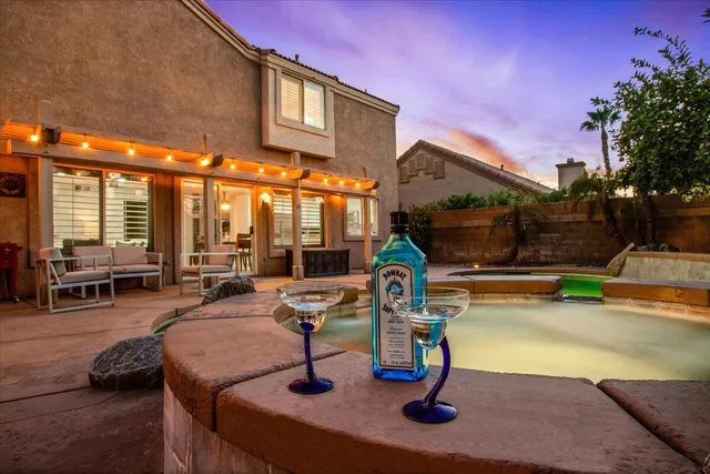 a swimming pool with outdoor seating
