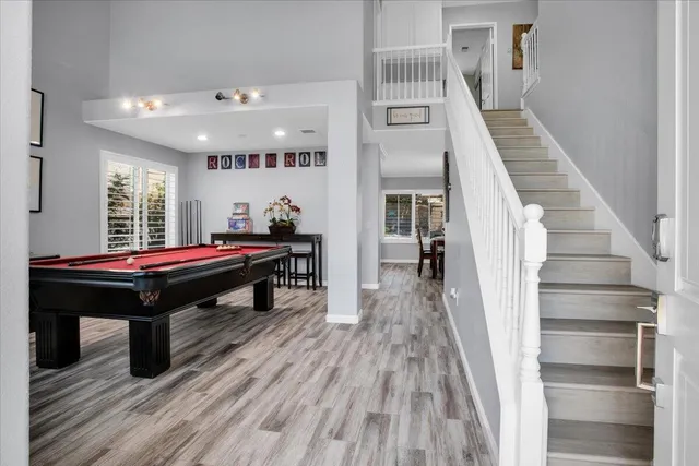 a room with wooden floor and stairs