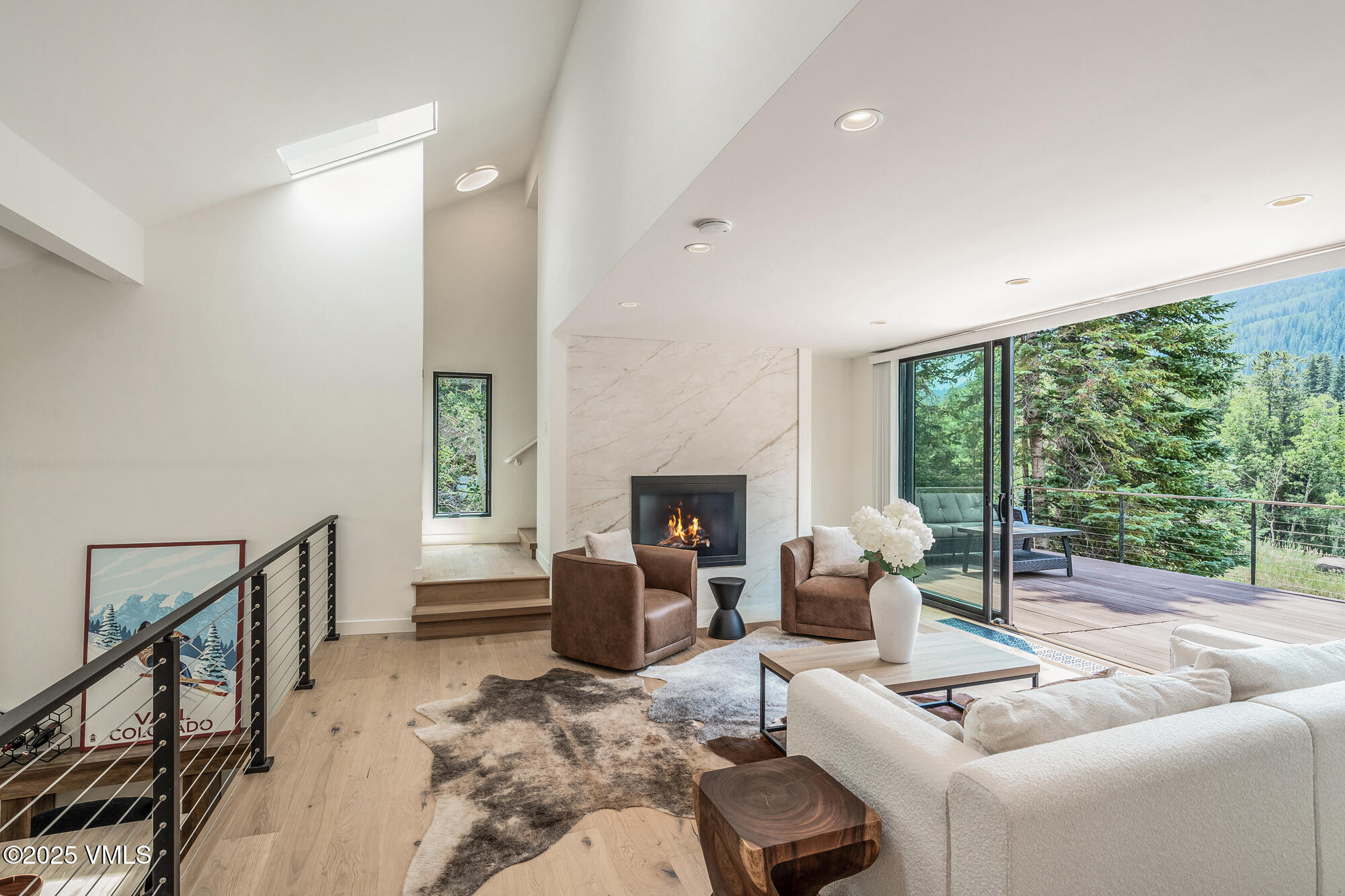 4545 Big Horn Road Vail, CO 81657 - Photo 10 of 49 a living room with furniture a fireplace and a floor to ceiling window