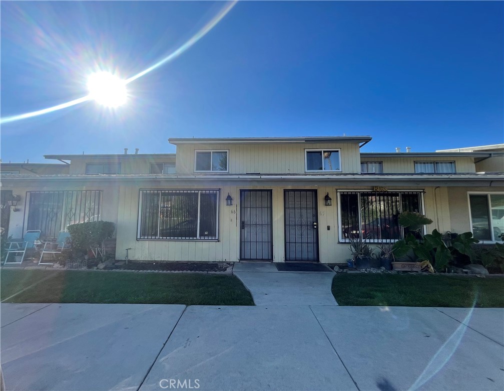 2350 Osbun Road, Unit 66 San Bernardino, CA 92404 - Photo 1 of 6 a front view of house with yard and outdoor seating