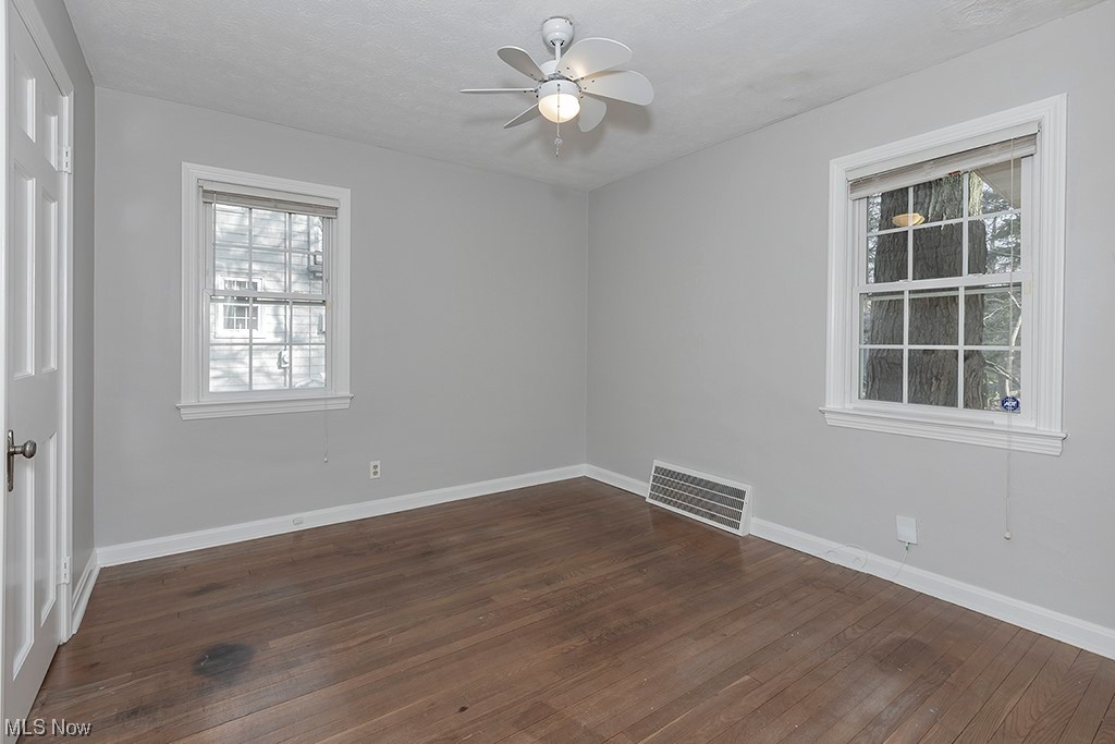 863 Roland Road Cleveland, OH 44124 - Photo 16 of 32 Unfurnished room featuring dark hardwood / wood-style flooring and ceiling fan