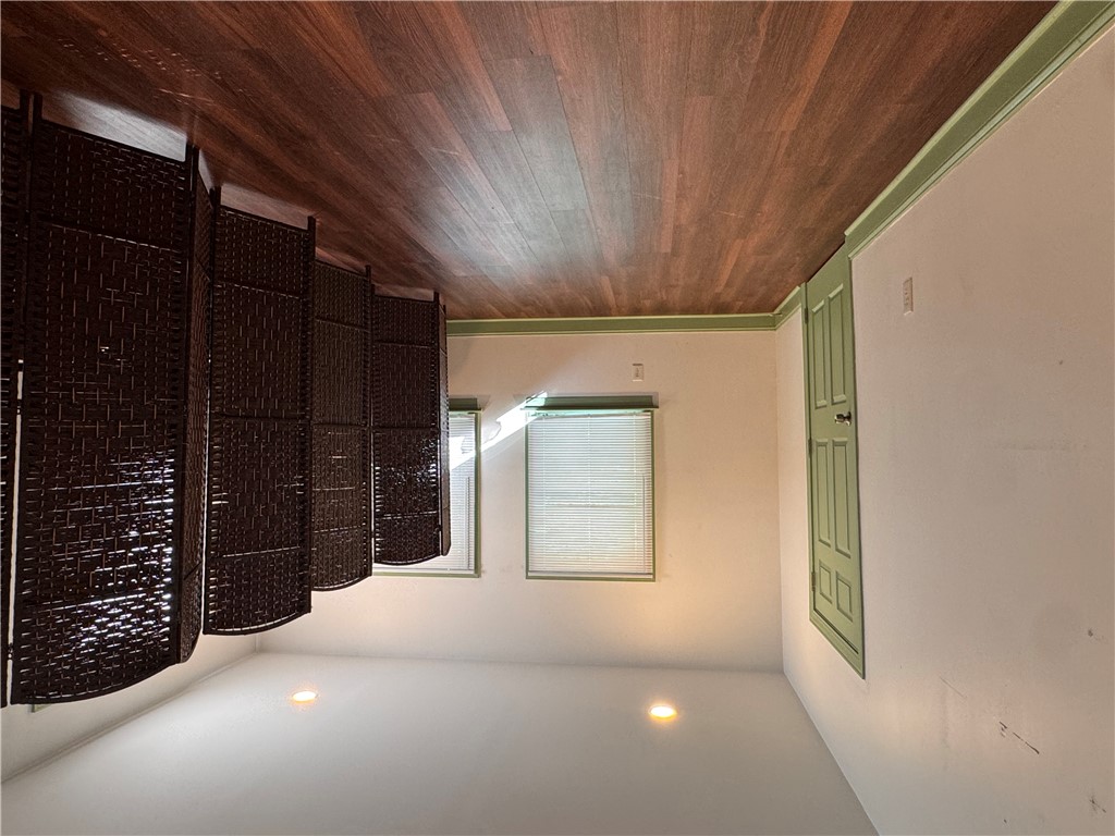 2211 East River Street Anderson, SC 29621 - Photo 8 of 40 This versatile room features warm wood flooring and recessed lighting, creating an inviting atmosphere.