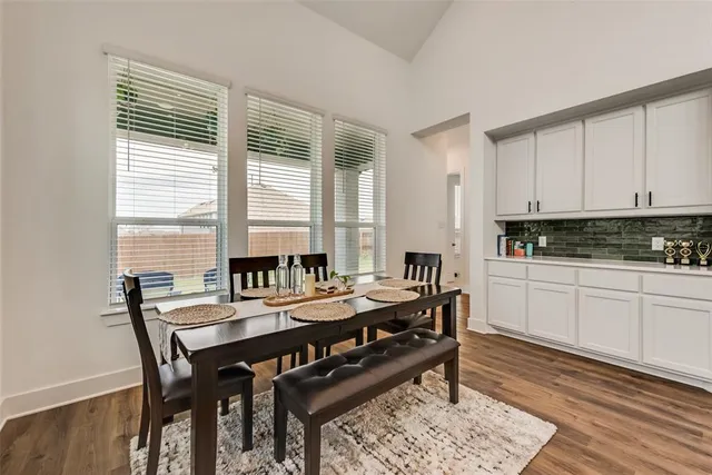 a view of a a dining room with furniture window and wooden floor