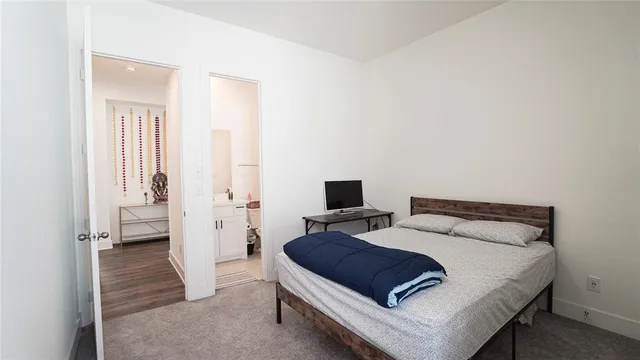 a bedroom with a bed and a view of bathroom