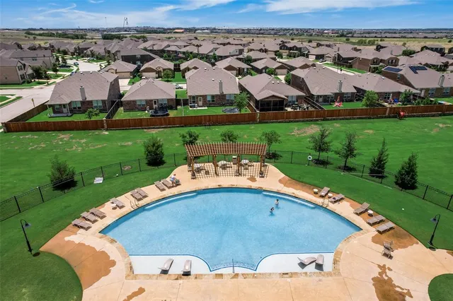 an aerial view of a house with yard swimming pool and outdoor seating