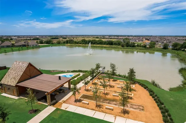 an aerial view of a house with a lake view